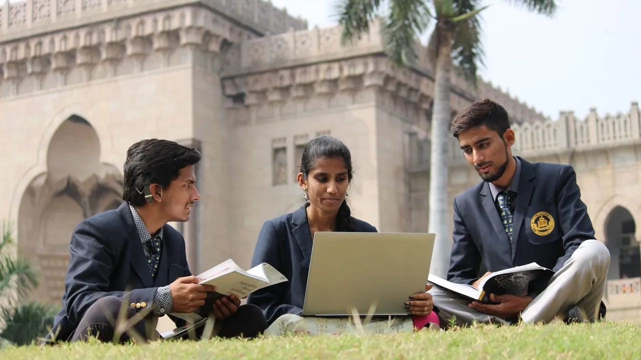 College students working together on a laptop on campus