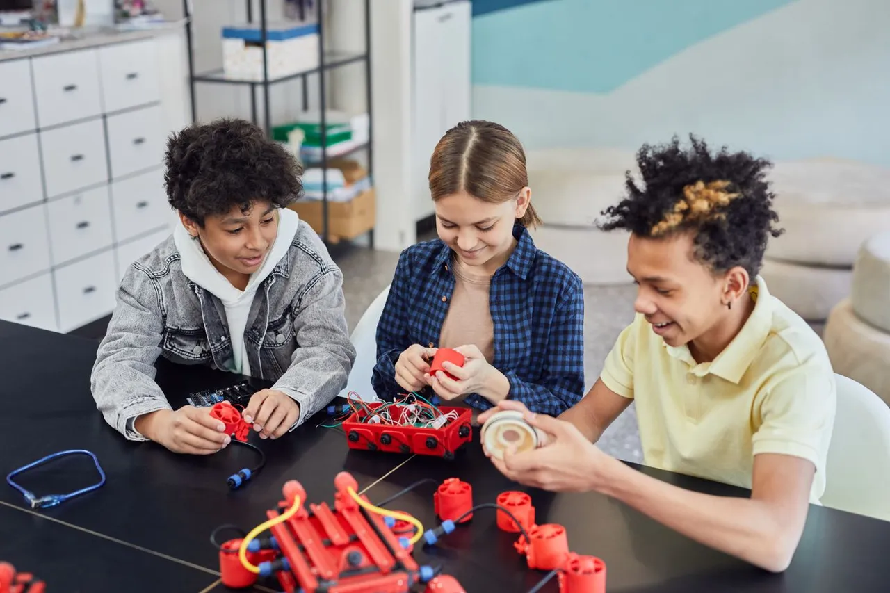 Students building a robot together in a technology lab