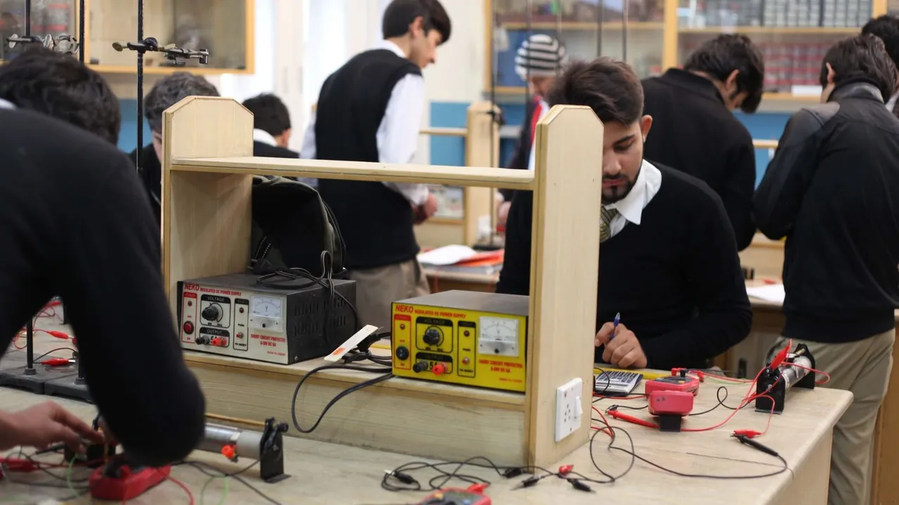 Diploma students running practicals at electronics lab benches